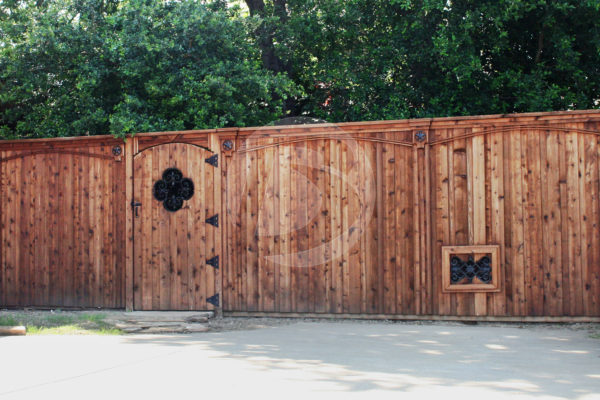 Stained wood fence with wood gate, clover decorative ornamental window