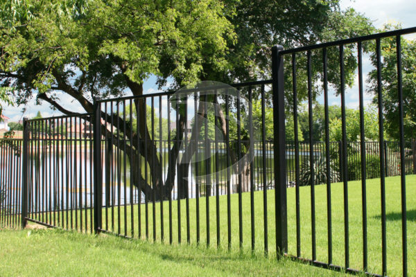 Black ornamental perimeter fence panels surrounding neighborhood pond