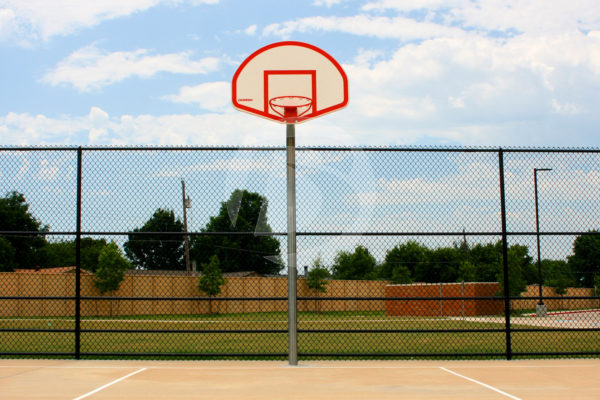 Vinyl coated black chain link fence surrounding a basketball court