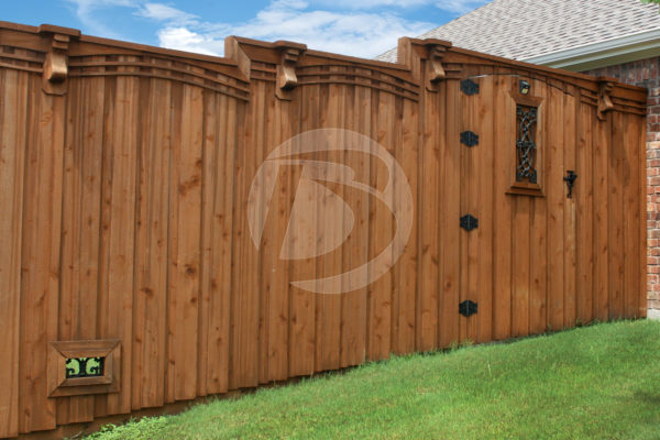Board on Board staggered height wood fence with black gate hardware and ornamental gate accent
