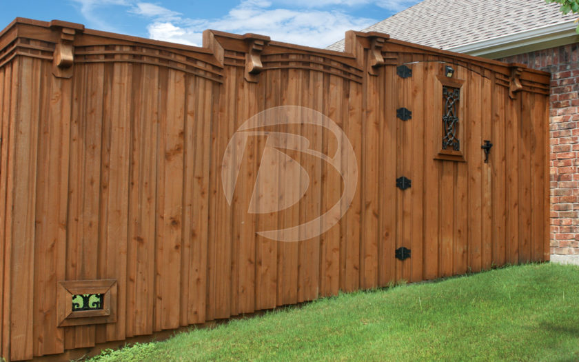 Board on Board staggered height wood fence with black gate hardware and ornamental gate accent