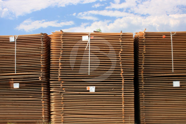 Stacked wood fencing to air dry before staining