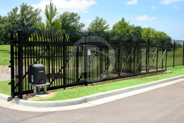 Black perimeter fence with a sliding access controls gate and control box