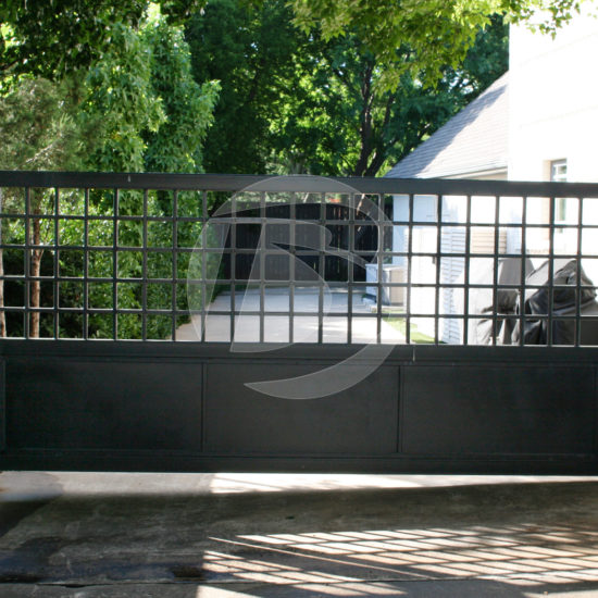 Black swing access controls gate for driveway entrance