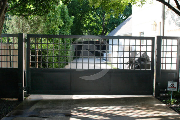 Black swing access controls gate for driveway entrance