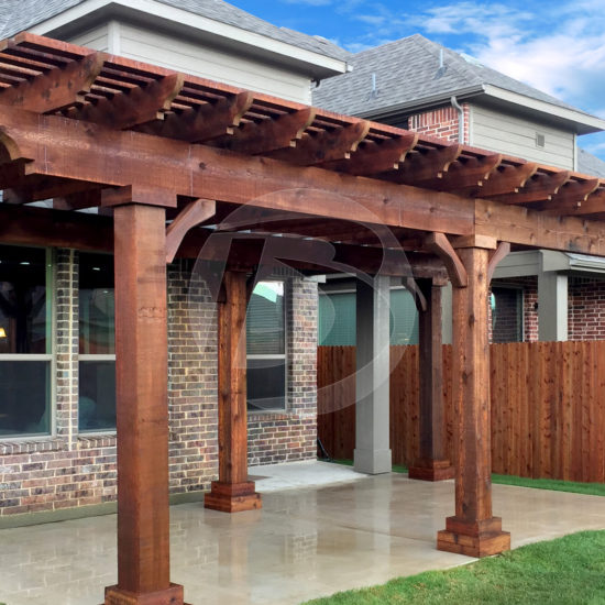 Brown stained cedar pergola in backyard with wood posts and wood corbels