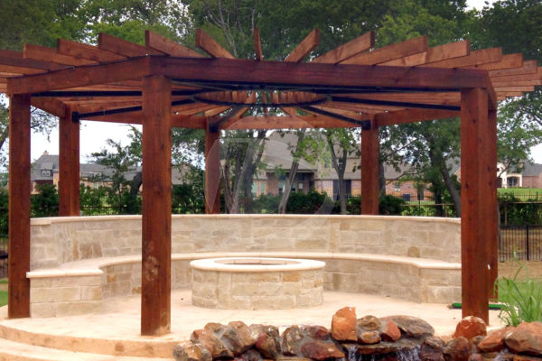 Round dark brown stained cedar pergola around fire pit