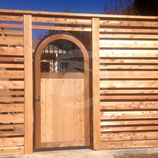 Horizontal clear stain cedar fence with cedar arched door