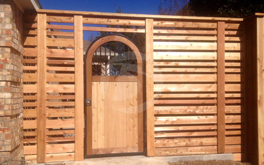 Horizontal clear stain cedar fence with cedar arched door