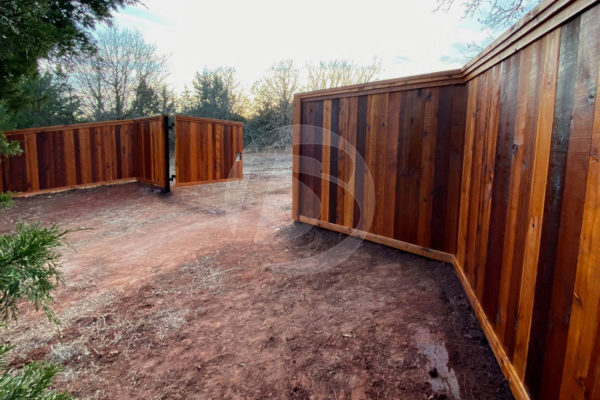 Multi clear stain cedar fence with opened access controls swing gate