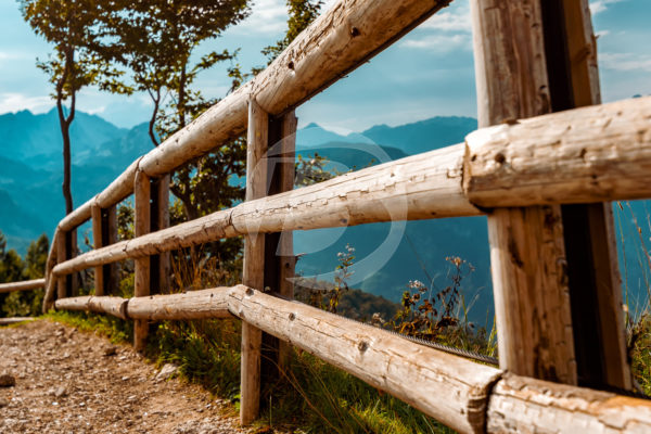 Wood Round Rail fencing along a mountainside.