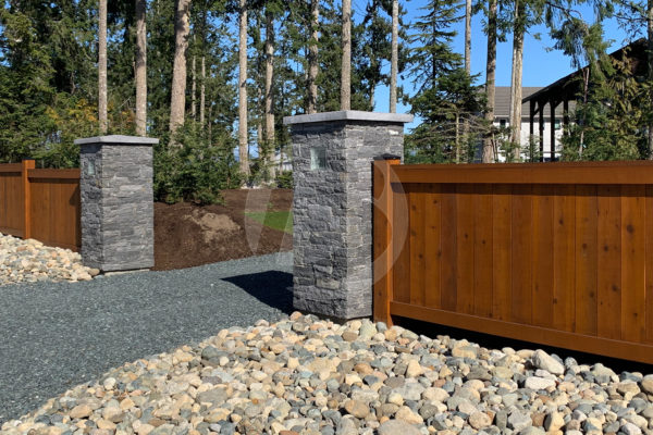 Stained wood Cedar fence at gravel entryway
