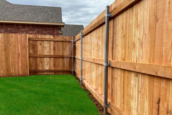 Cedar wood fence with galvanized post and fittings includes top cap and wood rails