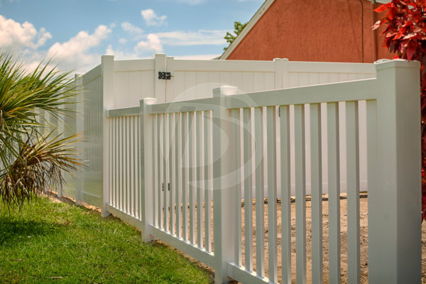White vinyl open rail fence with a white vinyl perimeter fence with gate