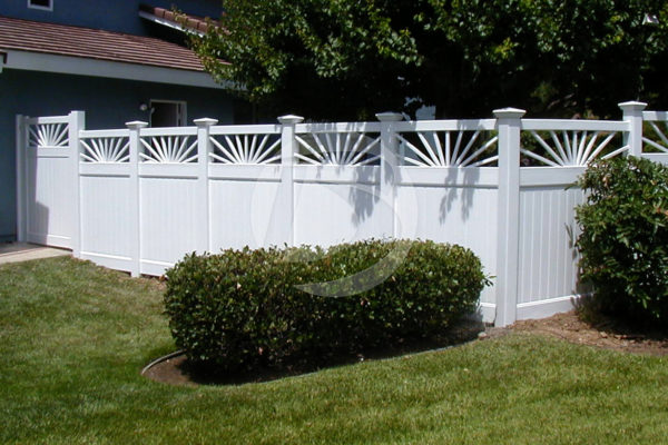 Decorative sunburst privacy white vinyl fencing around a house