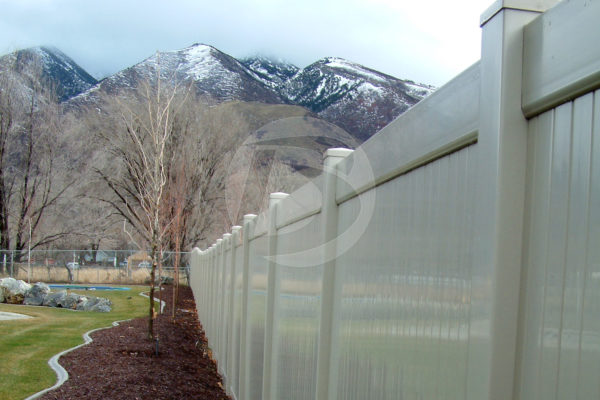 White side by side vinyl fence with snow cap mountains