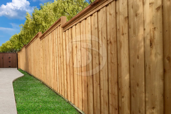 Board on Board unstained cedar fence angled with a stair step cap
