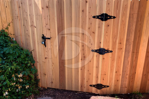 unstained cedar fence with gate hardware and latch