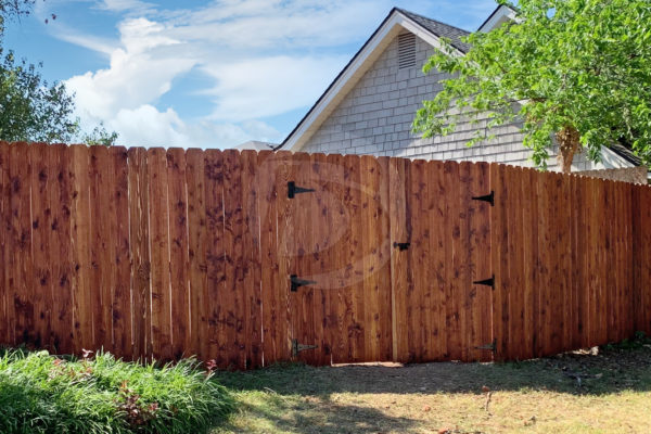 Stained cedar fence with gate hardware
