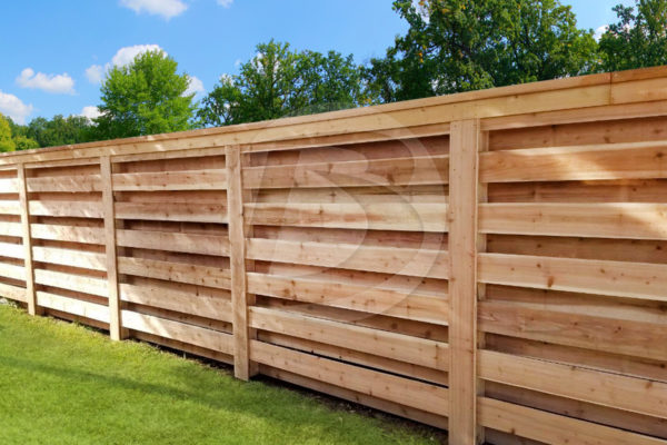 Horizontal cedar fence unstained with cedar top cap and a cedar post box